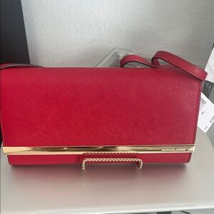 Michael Kors Red Scarlet Clutch or Cross body bag with Gold trim Accents.